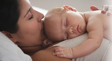 Mom with baby sleeping on chest